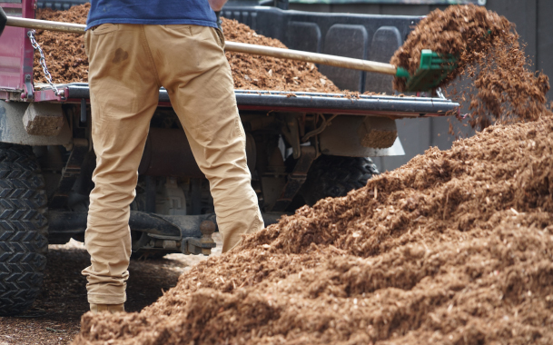 Mulch Man Shoveling Pile of Mulch